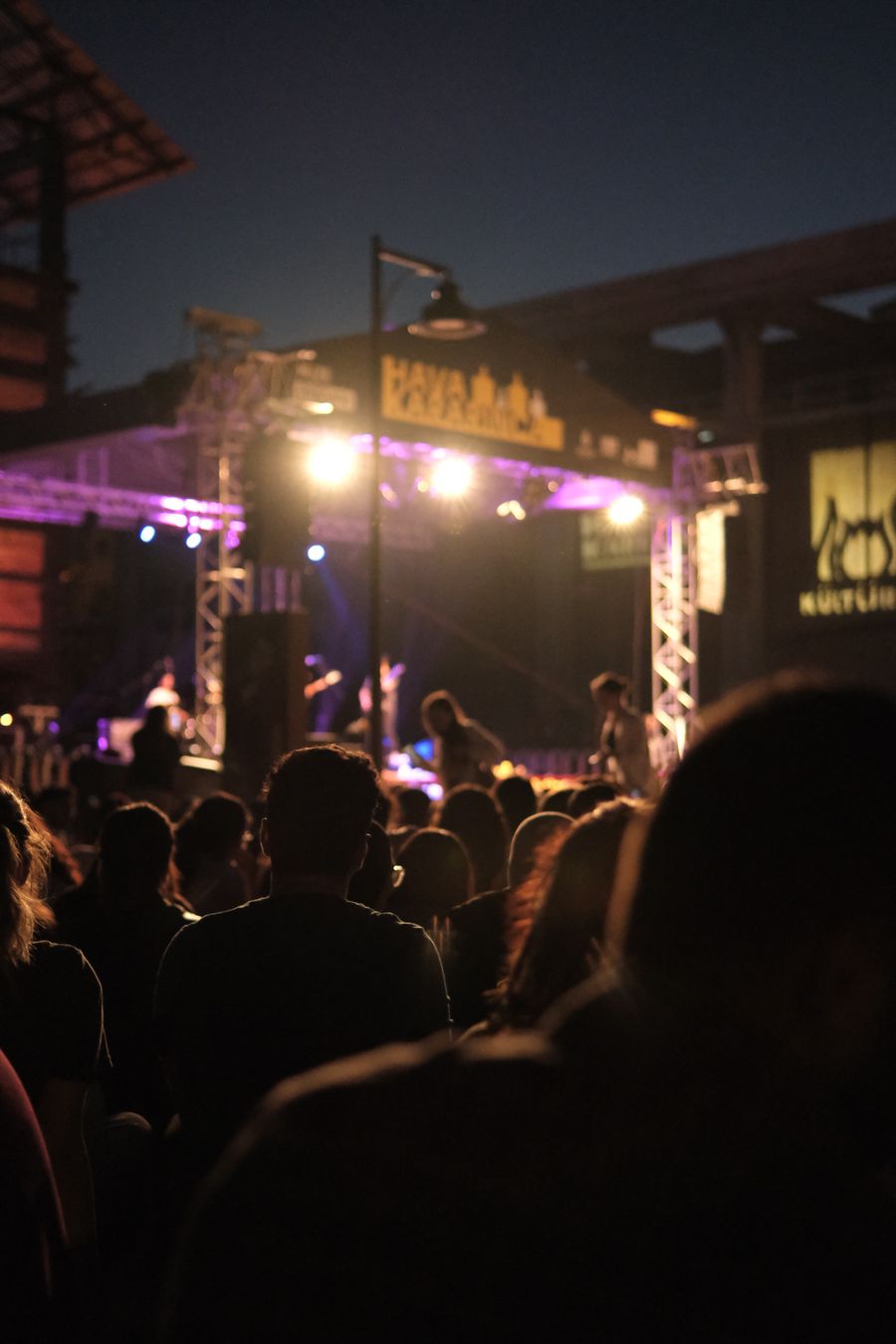 Outdoor stage with live music and a crowd at night
