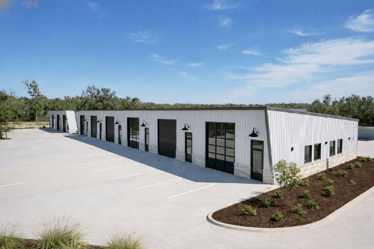 Modern white metal flex warehouse with drive-in bay doors